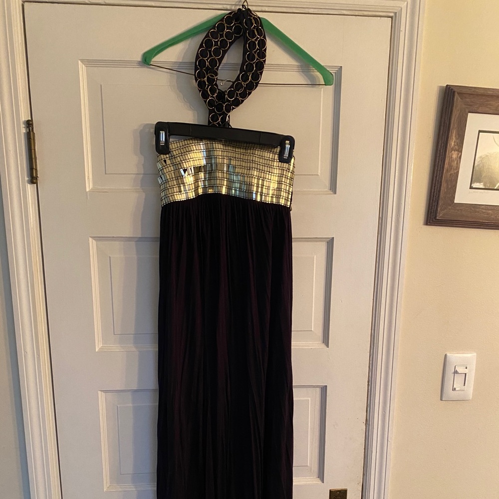 Authentic Icon black maxi dress with gold neck piece.